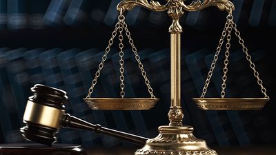 Law legal system crime concept with gavel and scales of justice with books in the background. (mallet, judicial system).