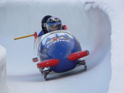 A French national two-man bobsled team participating in a run.
