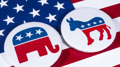 The Elephant symbol of the Republican Party and the Donkey symbol of the Democratic Party, with the American flag behind