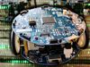 Observe the testing of micro-robots to sort out the better equipped and the more intelligent