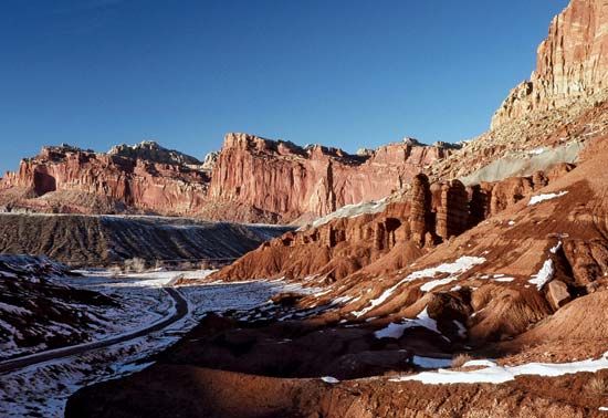 Cliffs along Scenic Drive (left foreground) in winter, Capitol Reef National Park, south-central Utah, U.S.