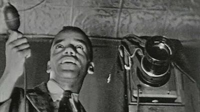 Observe James Latimer Allen working in his photography studio